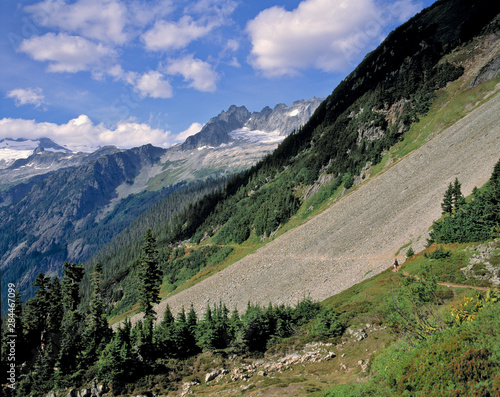 USA, Washington State, North Cascades NP. A narrow trail cuts across a gravel slope at Cascades Pass, in North Cascades NP, Washington State.