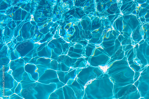 Reflections and patterns of light in a swimming pool.