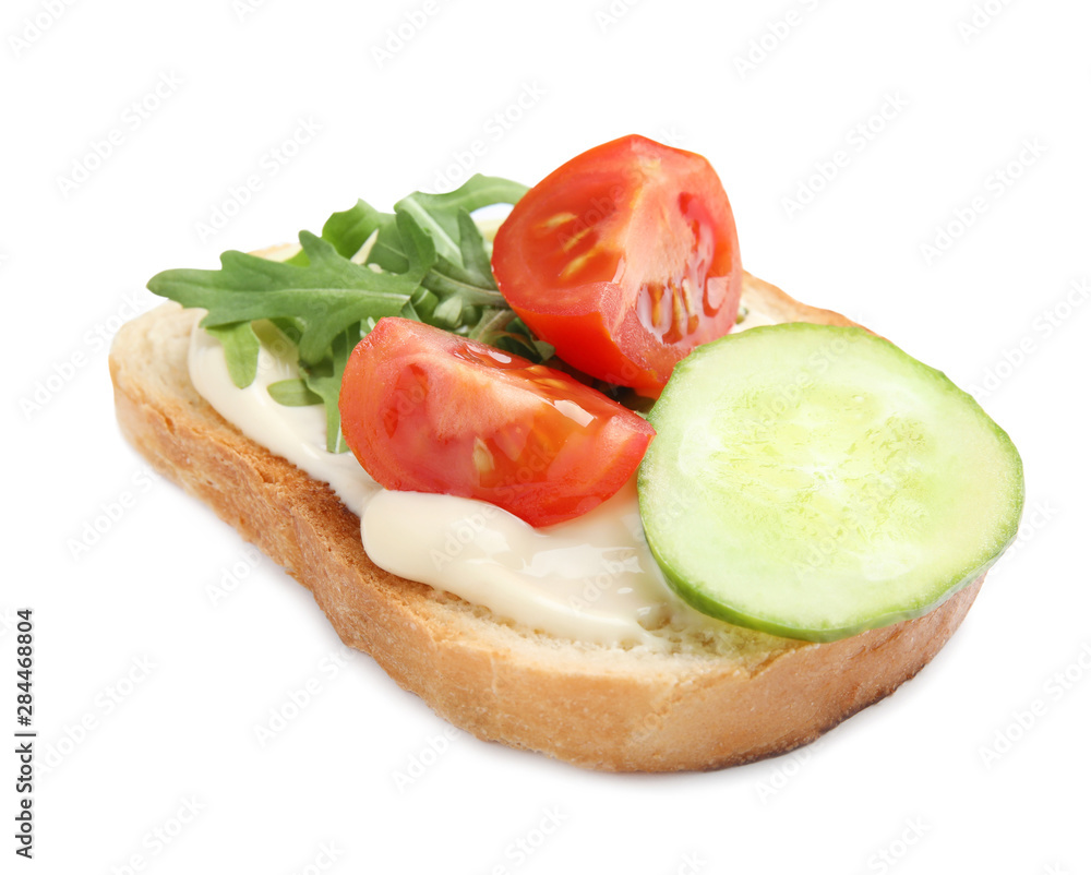 Slice of bread with spread and vegetables on white background