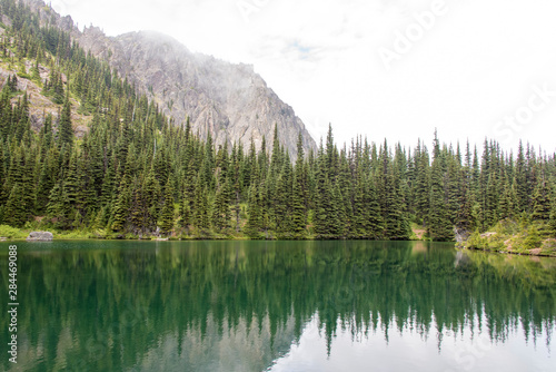 USA, Washington State, Olympic National Forest. Silver Lake in Buckhorn Wilderness. Meditative reflection on flat calm lake