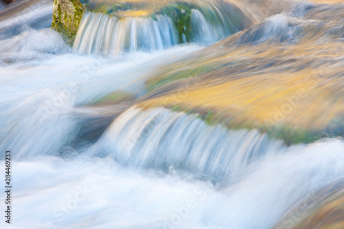 Wyoming, Sublette County, Close-up of Pine Creek flowing over rocks with slow shutter speed creating blurred motion.