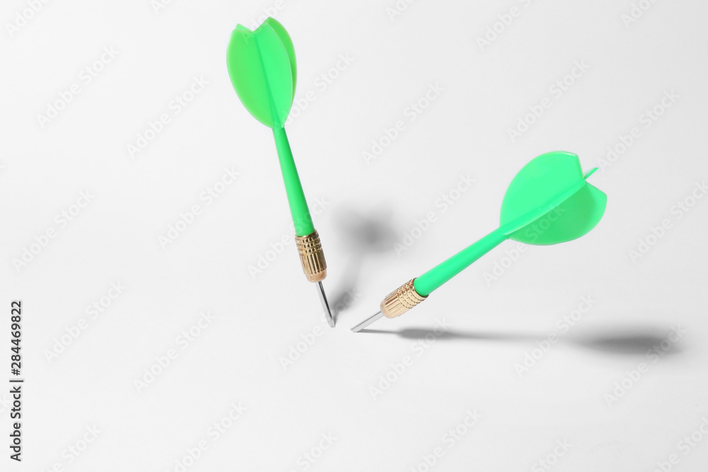 Green dart arrows for game on white background Green dart arrows for game on white background