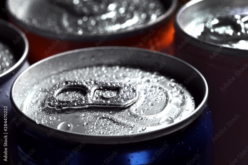 Aluminum cans of beverage covered with water drops as background, closeup Aluminum cans of beverage covered with water drops as background, closeup