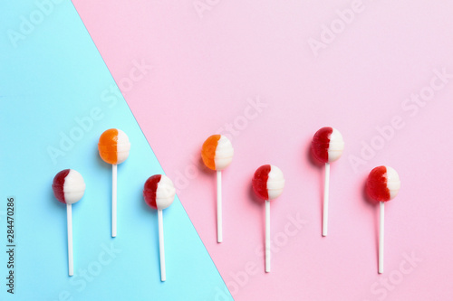 Delicious lollipop candies on color background. Space for text © New Africa