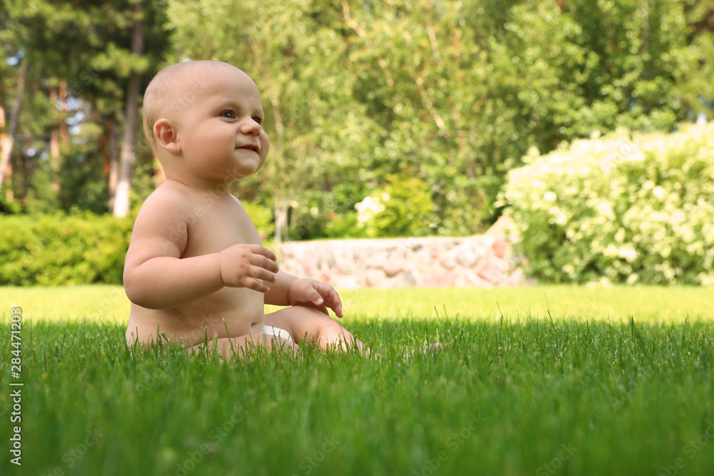 Little baby on green grass at backyard. Space for text Little baby on green grass at backyard. Space for text