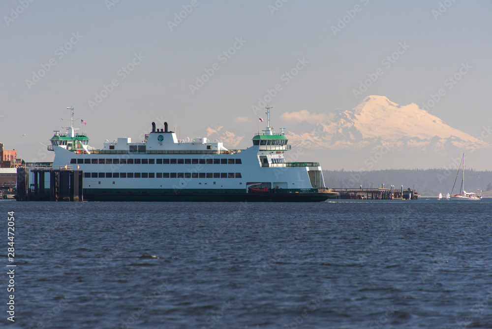 USA, Washington State. Ferry arrives at Port Townsend from Whidbey Island, with Mount Baker in background. USA, Washington State. Ferry arrives at Port Townsend from Whidbey Island, with Mount Baker in background.