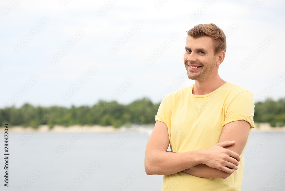 Portrait of handsome man with crossed arms in city Portrait of handsome man with crossed arms in city