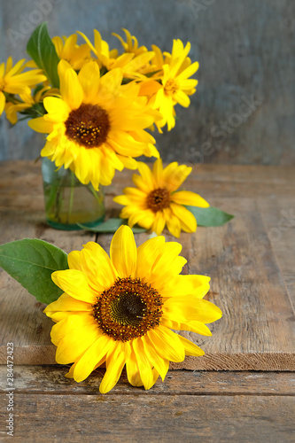 Beautiful Yellow Sunflower Bouquet. autumn cozy still life. sunflowers on rustic wooden background. fall season concept. copy space. shallow depth, soft selective focus.