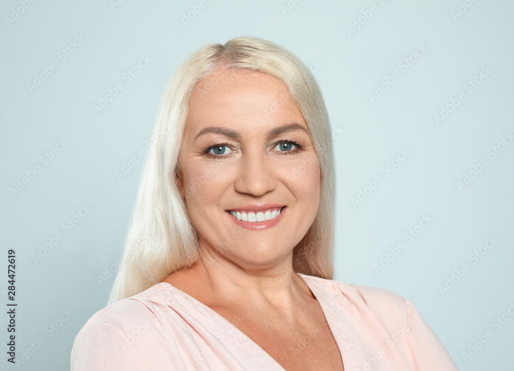 Fototapeta premium Portrait of mature woman with beautiful face on grey background