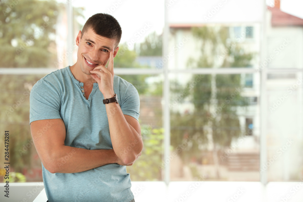 Portrait of handsome young man indoors. Space for text