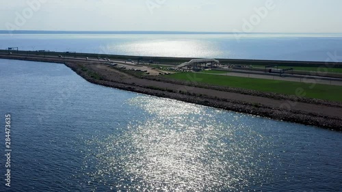 Arial over blue water at the Dark Sea Crimea with ramp to landbridge photo