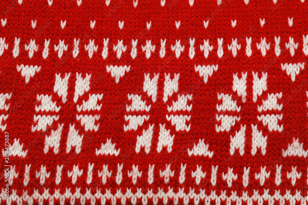 Warm red Christmas sweater as background, closeup view Warm red Christmas sweater as background, closeup view