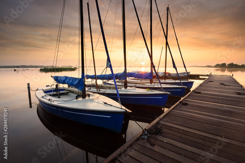 Fototapeta Naklejka Na Ścianę i Meble -  serene charming harbor at sunrise with yachts