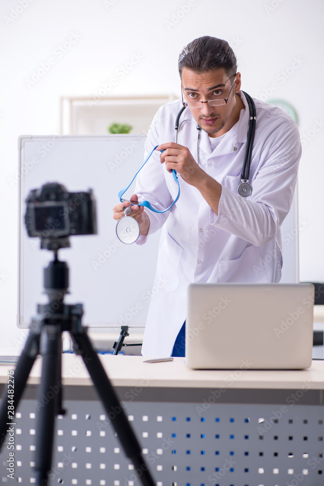 Young male doctor recording video for his blog Young male doctor recording video for his blog