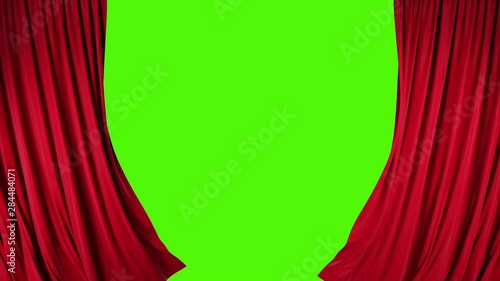 Red velvet theater curtains in motion. Opening and closing curtains with green chroma key. photo