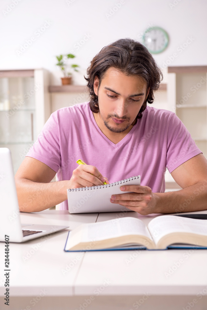 Young male student preparing for exams at home Young male student preparing for exams at home