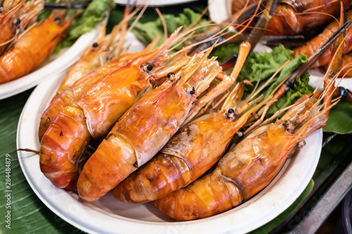 Fresh baked represents a delightful at the street food market. Discover the vibrant appeal of fresh food like shrimp. photo