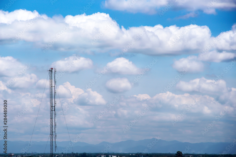 Landscape blue sky with white clouds group pattern floating and high antenna transmission tower on summer background