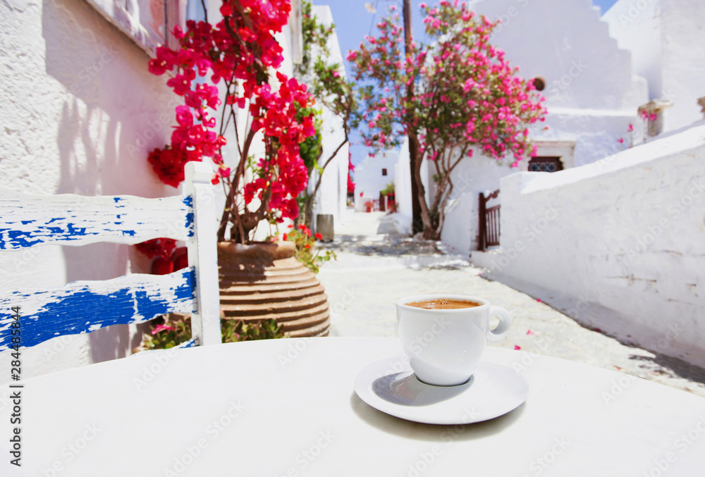 Traditional greek coffee in a cafe with beautiful mediterranean street on the background - obrazy, fototapety, plakaty 
