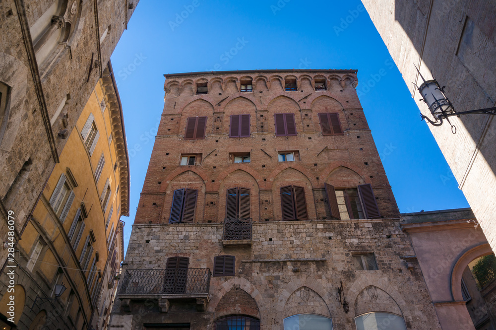 Medieval building of red brick on Piazza del Campo in Siena, Italy