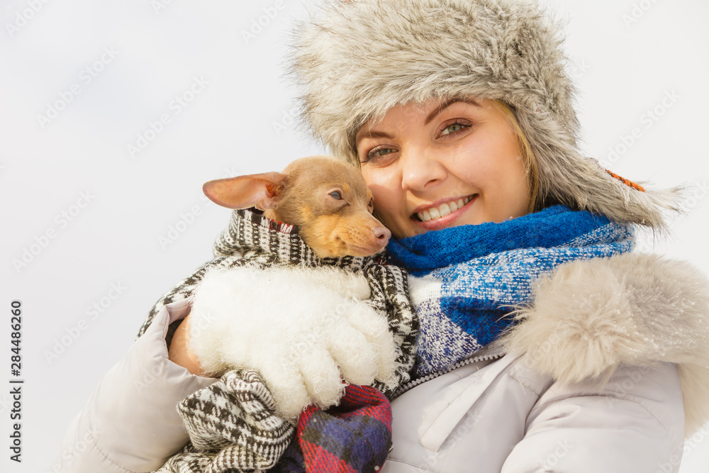 Woman hug warming her dog in cold day Woman hug warming her dog in cold day