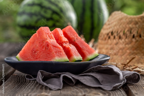 Closeup of juicy and tasty watermelon in summer garden photo