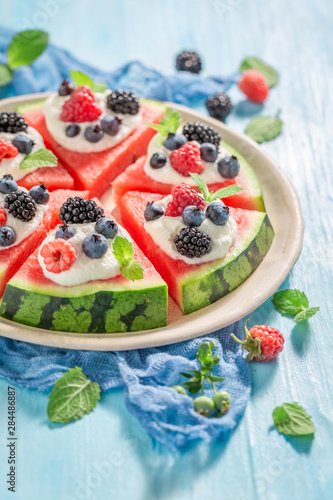 Watermelon pizza with blueberries, raspberries and cream