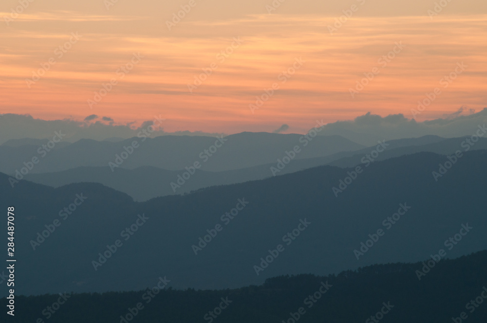 Peaceful nature landscape background with mountains on sunset