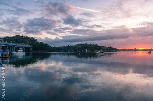 Canvas Print Beautiful sunrise over river with yachts and water view houses