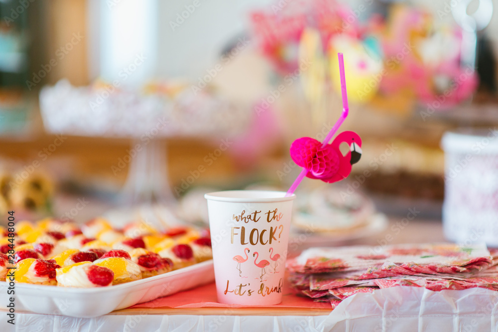 party decoration with a paper cup and flamingo straw 