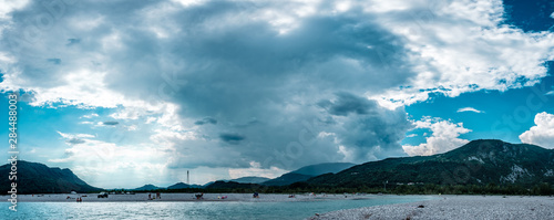 Storm over Tagliamento river in an hot summer day photo