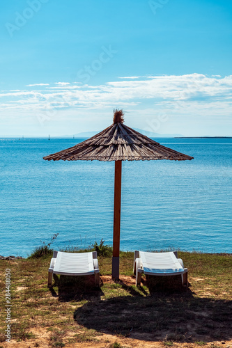 Fototapeta Naklejka Na Ścianę i Meble -  Beach umbrella at the sea in Premantura