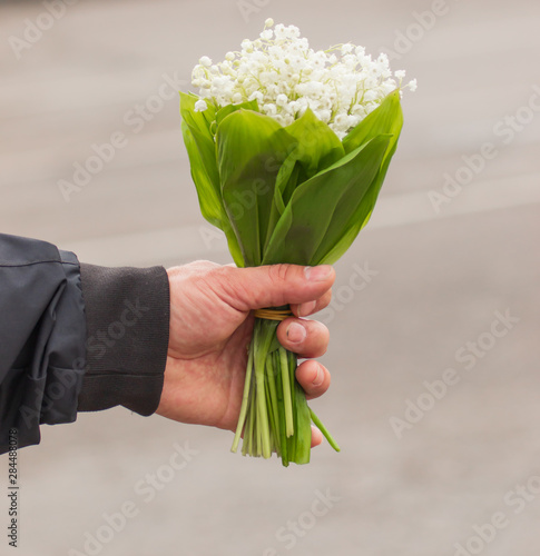 bouquet of lily of the valley in hand