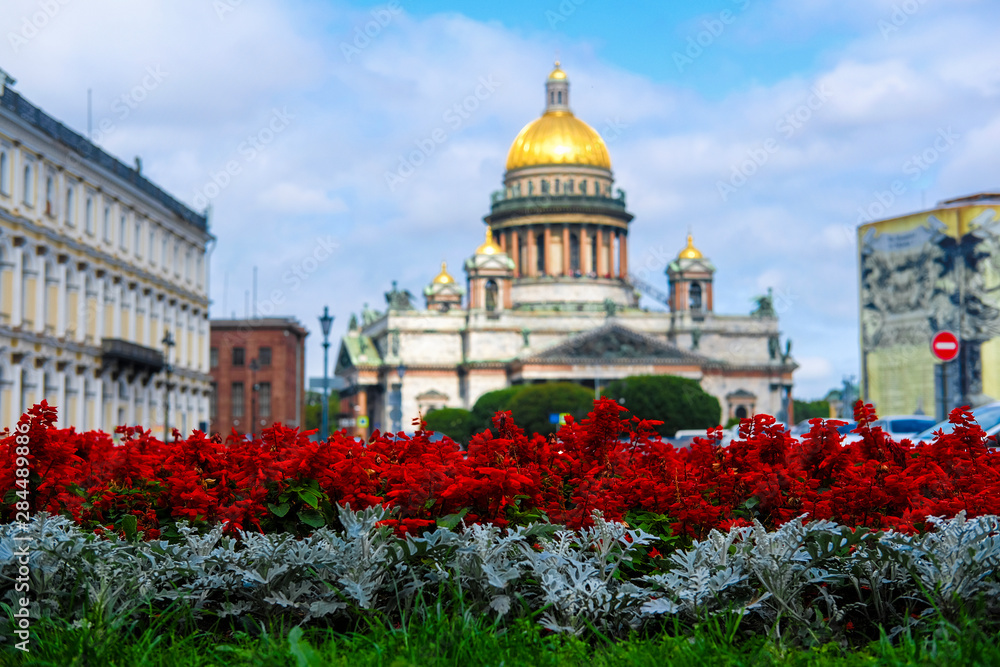 Saint Petersburg, Russia - August, 13, 2019: Saint Isaac Cathedral in Saint Petersburg, Russia and flowers on the frontground