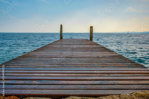 Fototapeta Naklejka Na Ścianę i Meble -  Landscape with the image of a pier on Garda lake in Italy