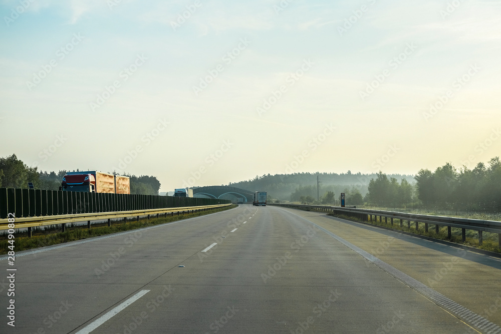 Warshaw, Poland - July, 26, 2019: landscape with the image of a road in Poland at sunset