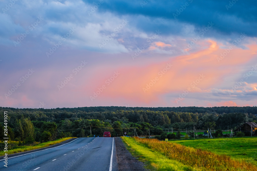 Moscow region, Russia - August, 9, 2019: Country road in Moscow region at sunset
