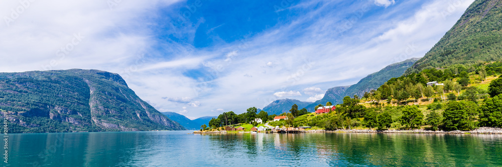 Fototapeta premium View on Ornes, famous for Urnes Stave Church, from the liitle ferry crossing Lustrafjorden between Solvorn and Ornes, Sogn og Fjordane in Norway.