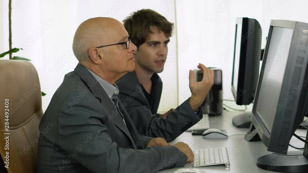 Young Office Worker Showing Idea On Computer To Boss
