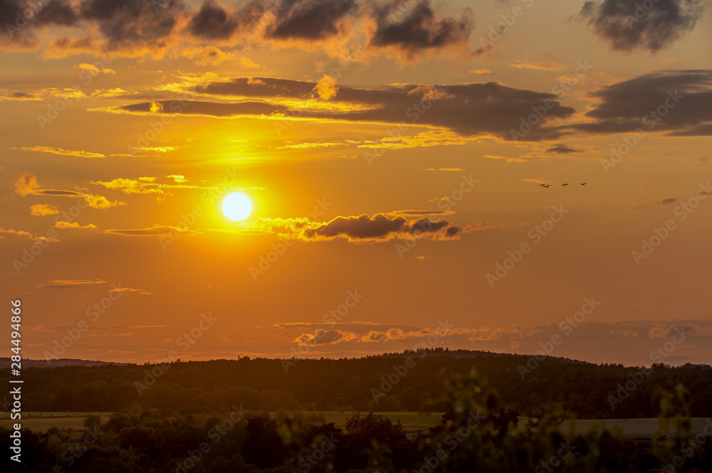 A beautiful sunrise with a golden sunshine on a late summer evening. Concept: landscape or sunset A beautiful sunrise with a golden sunshine on a late summer evening. Concept: landscape or sunset