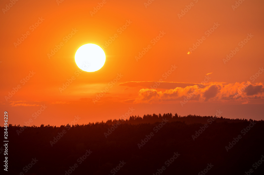 A beautiful sunrise with a golden sunshine on a late summer evening. Concept: landscape or sunset