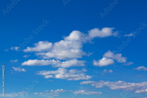 spindrift clouds in summer , blue sky background