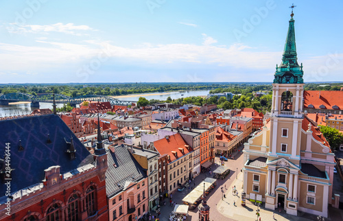Aerial view of the Vistula ( Wisla ) river with bridge and historical buildings of the medieval city of Torun, Poland. August 2019 photo