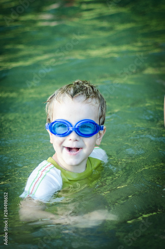 boy in swimming goggles on the river