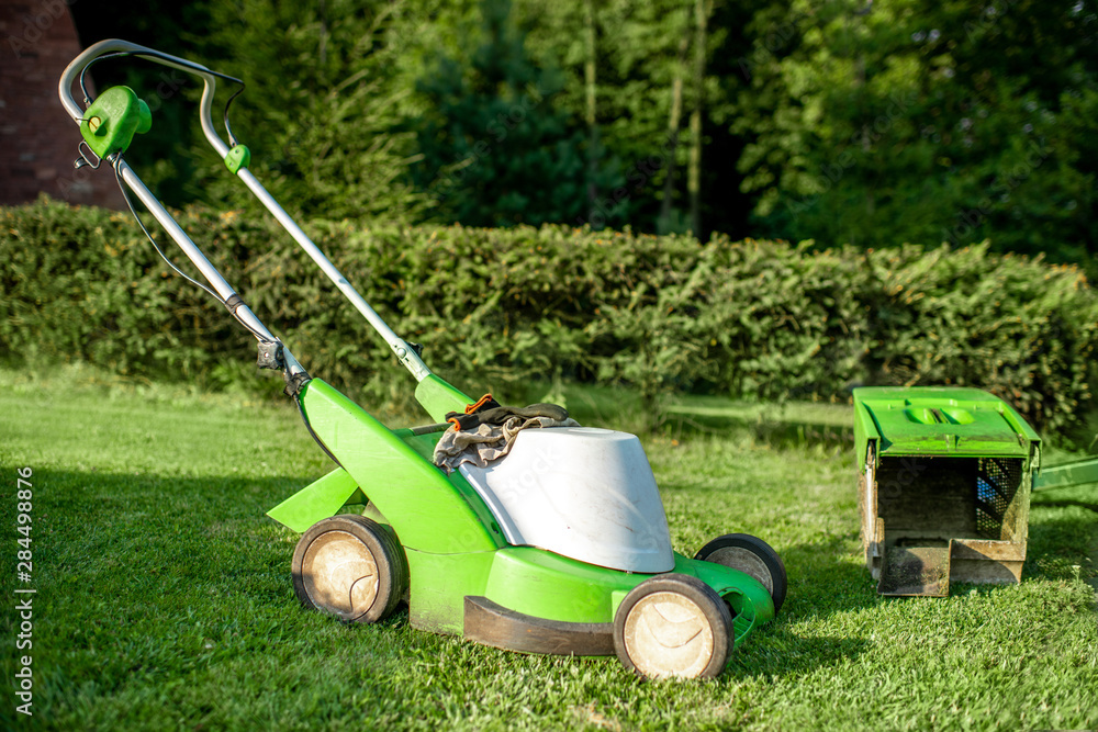 Lownmower on the grass outdooors Lownmower on the grass outdooors