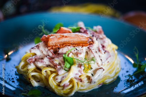 fresh italian spaghetti carbonara with tasty ingredients - cream, egg, bacon