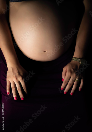 Pregnant Woman holding her tummy with 8 months pregnant