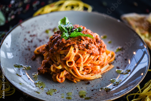 delicious italian spaghetti bolognese with minced beef sauce, tomatoes, carrots & fresh basil 