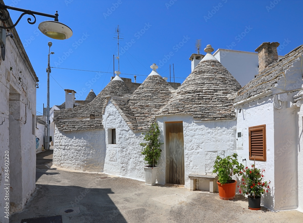 Street of a white Trulli houses. Apulia, Italy