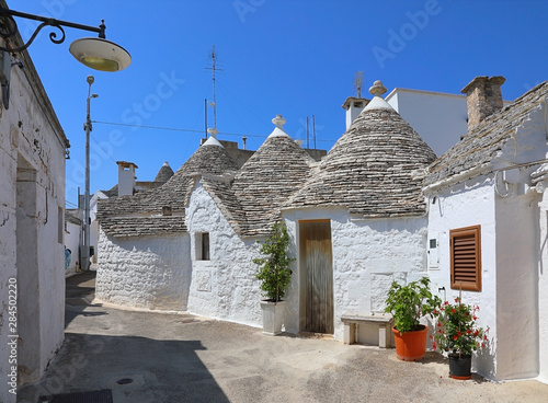 Street of a white Trulli houses. Apulia, Italy photo